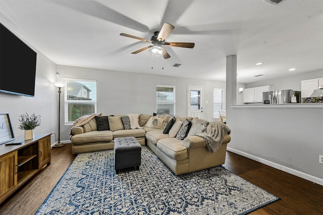 living room featuring wood-type flooring and ceiling fan