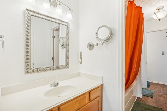 bathroom with vanity, a textured ceiling, and shower / bathtub combination with curtain