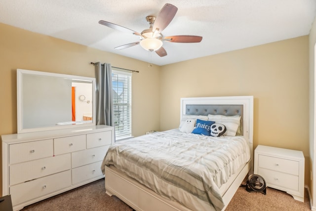 carpeted bedroom with a textured ceiling and ceiling fan