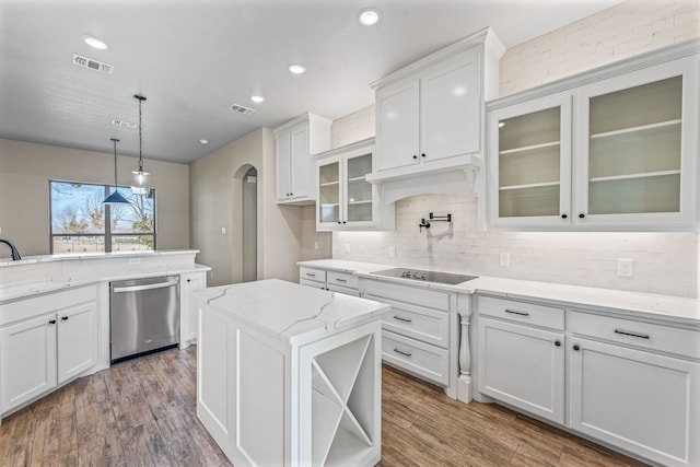 kitchen featuring white cabinets, hanging light fixtures, stainless steel dishwasher, dark hardwood / wood-style floors, and a kitchen island