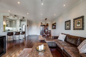 living room with dark wood-type flooring and ornamental molding