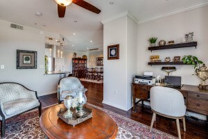 home office with ceiling fan, dark hardwood / wood-style flooring, and ornamental molding