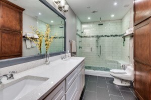 bathroom with toilet, vanity, tile patterned flooring, and a shower with shower door