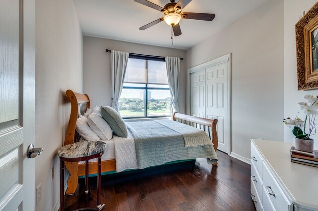 bedroom featuring dark wood-type flooring, a closet, and ceiling fan