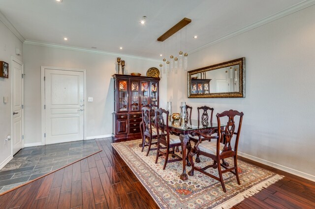 dining space featuring dark wood-type flooring and ornamental molding