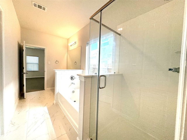 bathroom with independent shower and bath and a textured ceiling