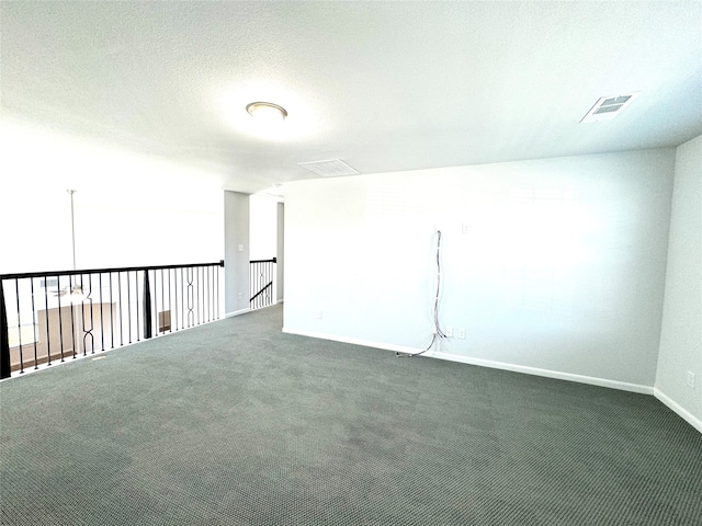 carpeted spare room with a textured ceiling