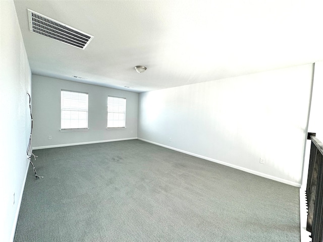 empty room featuring dark colored carpet