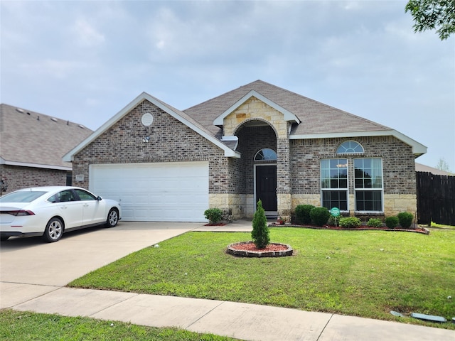 single story home featuring a garage and a front yard