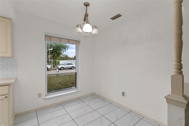 unfurnished dining area with a chandelier