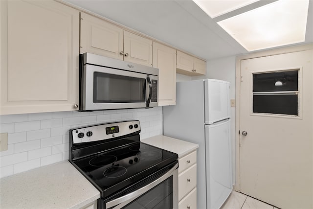 kitchen featuring stainless steel appliances and tasteful backsplash