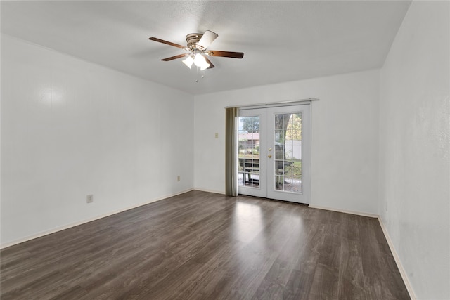 spare room with dark hardwood / wood-style flooring, french doors, and ceiling fan