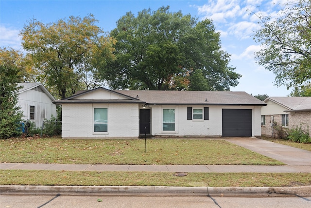 single story home featuring a front lawn and a garage