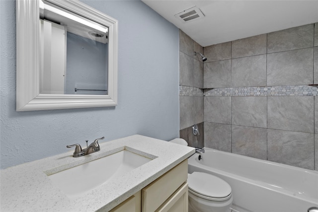 full bathroom featuring vanity, toilet, and tiled shower / bath