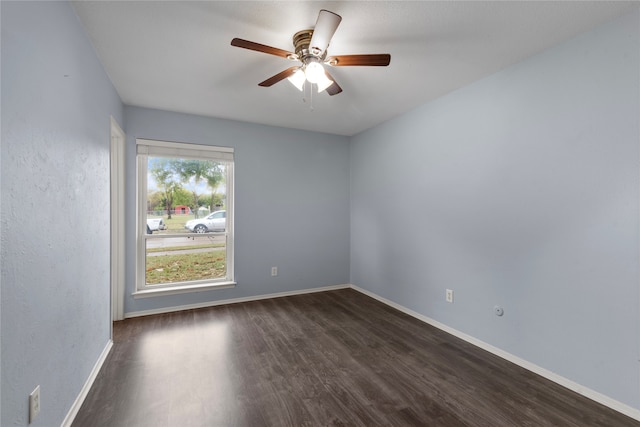 empty room featuring ceiling fan and dark hardwood / wood-style floors