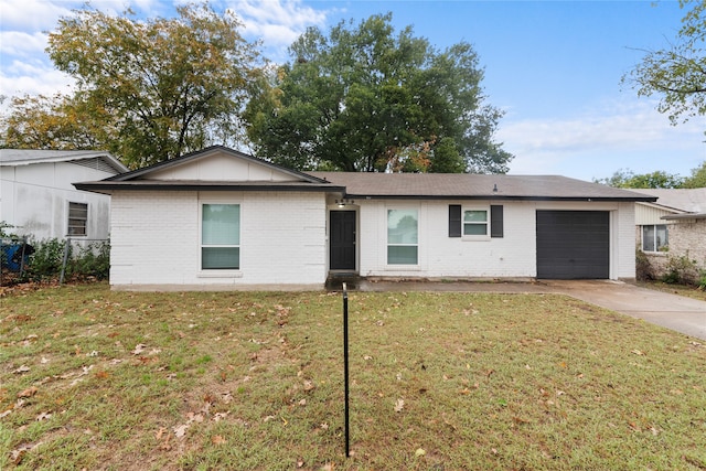 single story home featuring a garage and a front yard