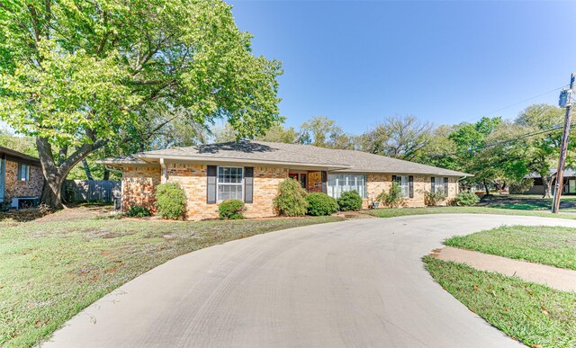 ranch-style house with a front lawn