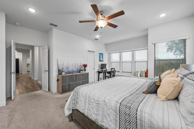 bedroom with light colored carpet and ceiling fan