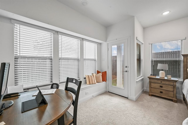 office space with a wealth of natural light and light carpet