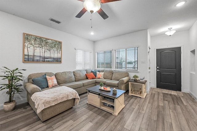 living room with wood-type flooring and ceiling fan