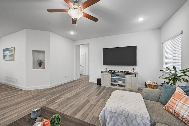 living room with hardwood / wood-style flooring and ceiling fan