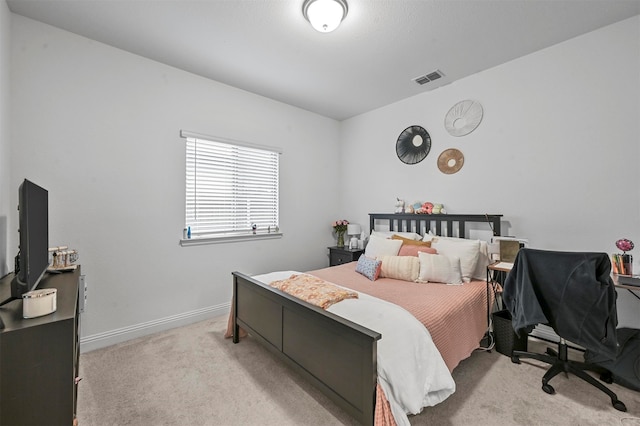 bedroom with light colored carpet