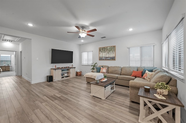 living room with ceiling fan and light wood-type flooring