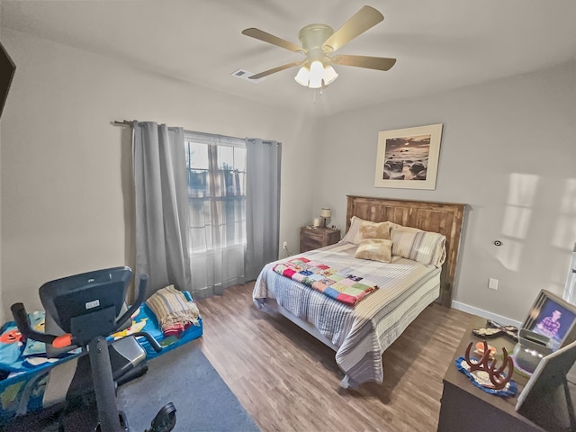 bedroom featuring hardwood / wood-style floors and ceiling fan