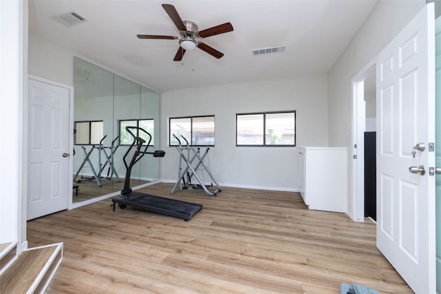 workout area featuring ceiling fan and light hardwood / wood-style flooring