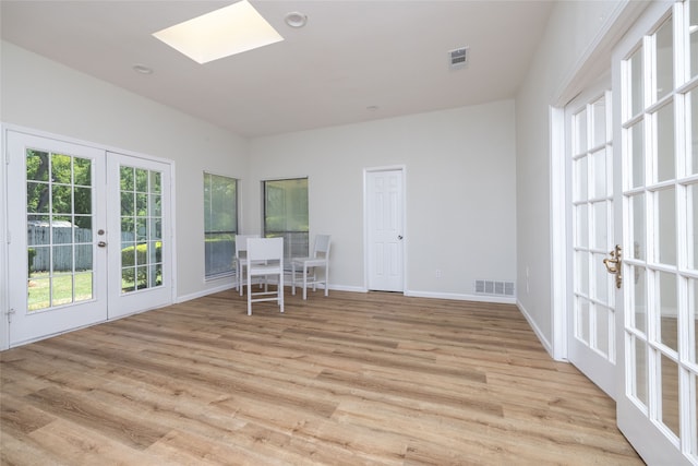 interior space with french doors and light wood-type flooring