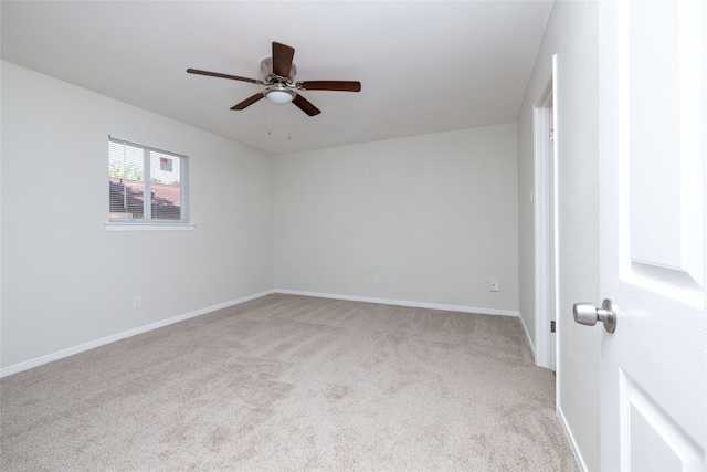 unfurnished room featuring light colored carpet and ceiling fan