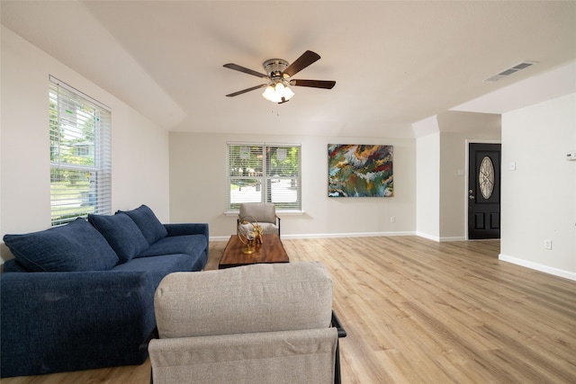 living room with hardwood / wood-style floors, ceiling fan, and plenty of natural light