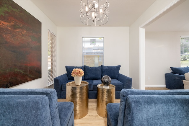 living room with hardwood / wood-style floors and a notable chandelier