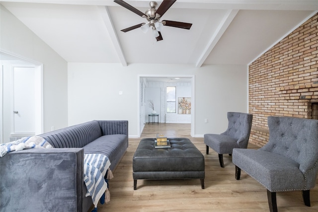 living room featuring ceiling fan, light hardwood / wood-style flooring, and vaulted ceiling with beams