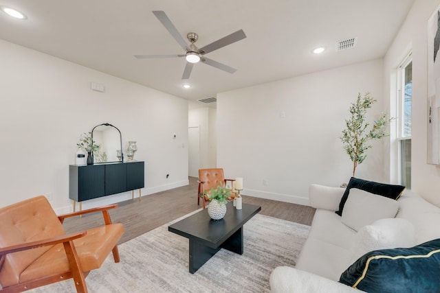 living room with recessed lighting, visible vents, and light wood-style flooring