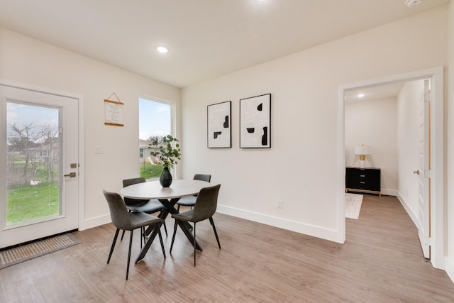 dining space with light wood-style flooring, baseboards, and recessed lighting