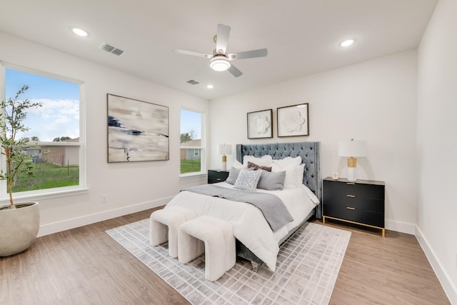 bedroom with visible vents, light wood-style flooring, and baseboards