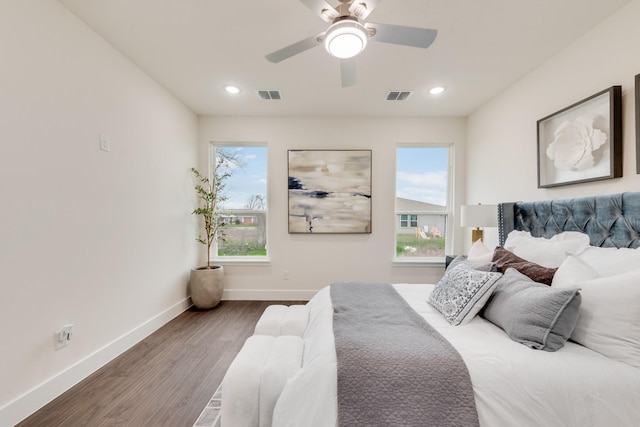 bedroom with recessed lighting, wood finished floors, visible vents, and baseboards