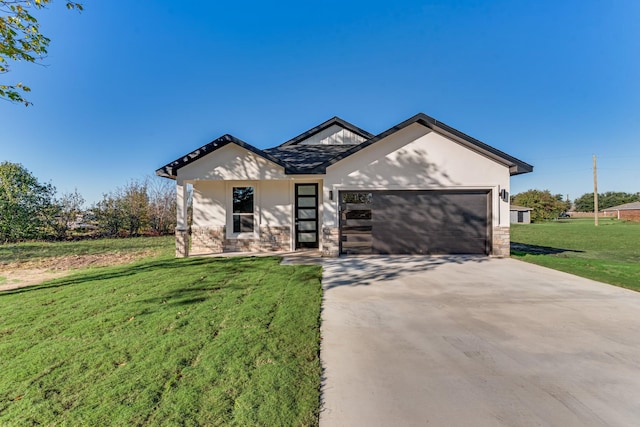 view of front of home with a garage, driveway, stone siding, and a front yard