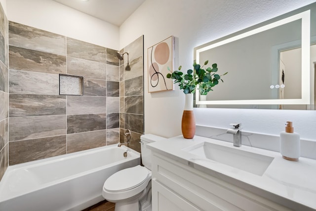 full bathroom featuring toilet, washtub / shower combination, and vanity