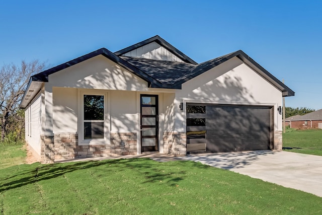 view of front of home featuring stone siding, a front yard, concrete driveway, and an attached garage