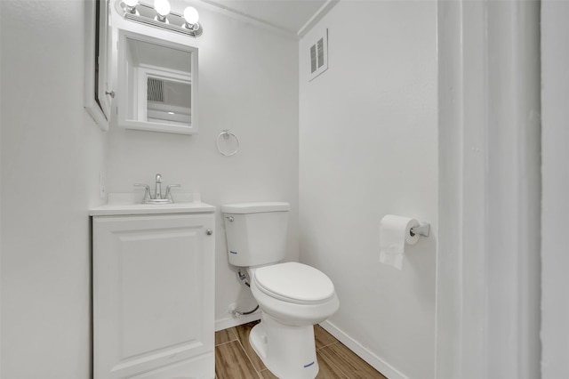 bathroom featuring hardwood / wood-style floors, vanity, and toilet