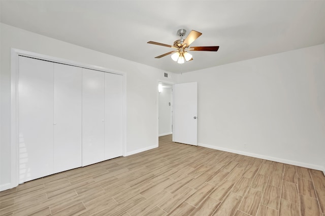 unfurnished bedroom with a closet, light wood-type flooring, and ceiling fan