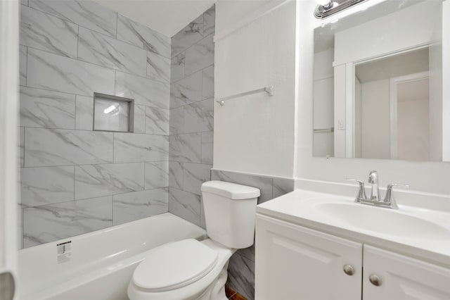 full bathroom with toilet, vanity, and tiled shower / bath