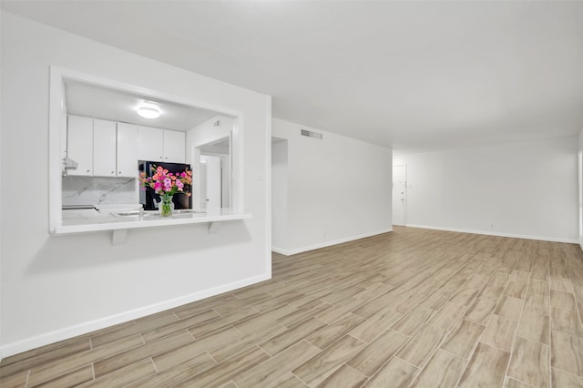 unfurnished living room featuring light hardwood / wood-style floors