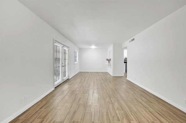 empty room with light hardwood / wood-style flooring