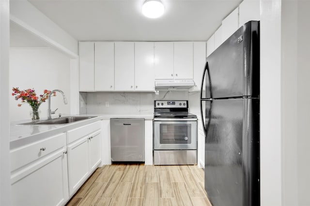 kitchen featuring light hardwood / wood-style floors, white cabinetry, sink, and appliances with stainless steel finishes