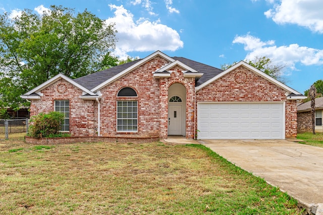 view of property with a garage and a front lawn