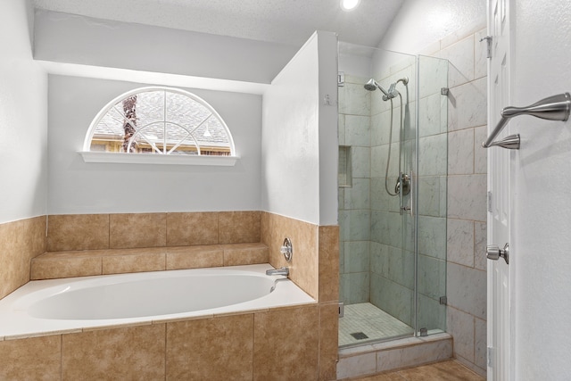 bathroom with a textured ceiling and plus walk in shower