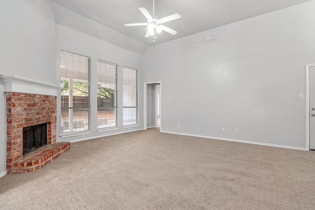 unfurnished living room with a brick fireplace, high vaulted ceiling, carpet floors, and ceiling fan